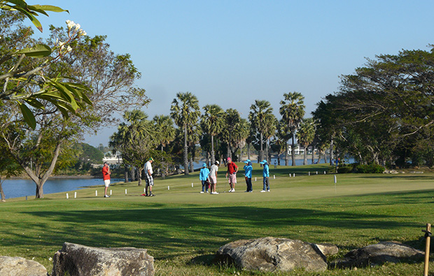 golfers putting, palm hills golf club, hua hin, thailand